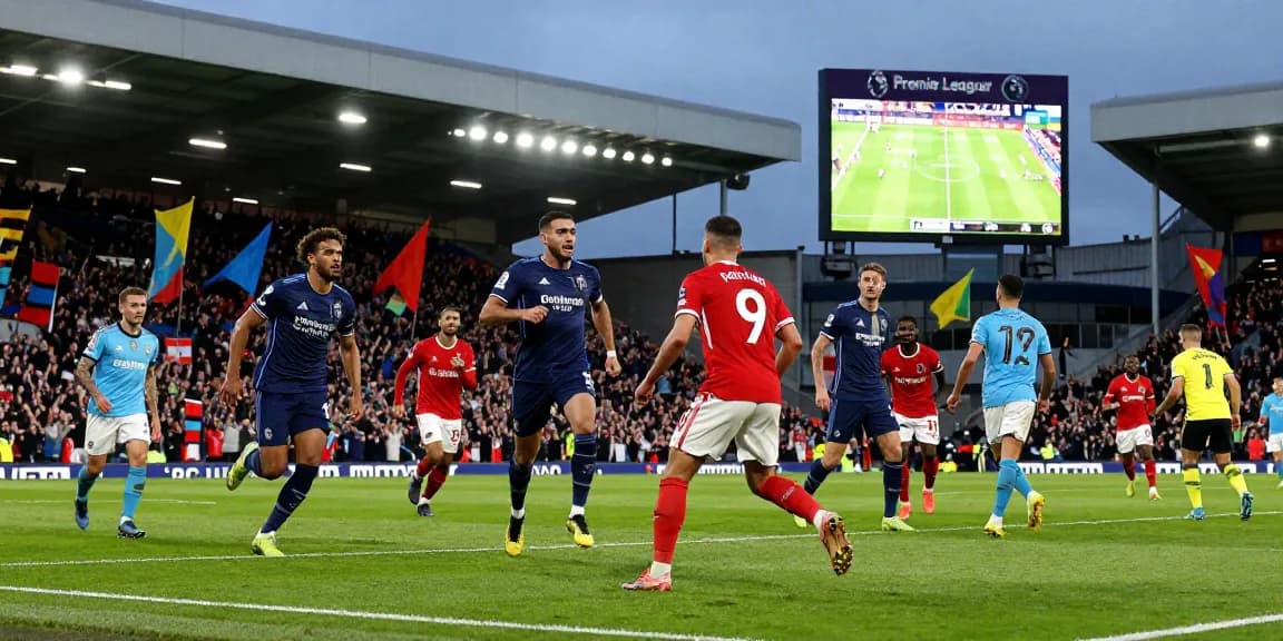 Action-packed Premier League match with bk8 branding amidst vibrant stadium atmosphere, showcasing players, fans, and live excitement.